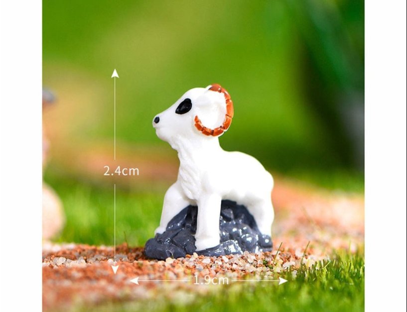 GOAT STANDING ON A ROCK MINIATURE